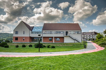 Fototapeta na wymiar The Park and the Old Vocational School in Prundu Bârgăului, modernized and expanded, September 2022