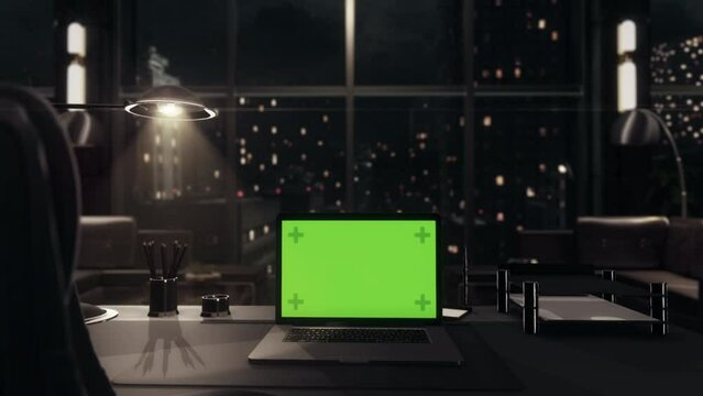 Laptop Computer with Green Screen Chroma Key Display on top of Corporate Office Desk. Late Night. Mockup.