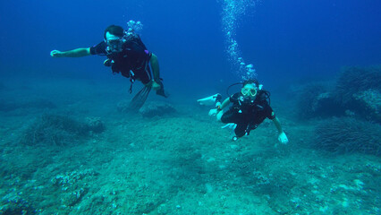 Fototapeta na wymiar Couple SCUBA Diving Off the Coast of Mallorca Spain