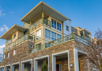 Brand new apartment building on sunny day in BC, Canada. Architectural details of modern apartment building