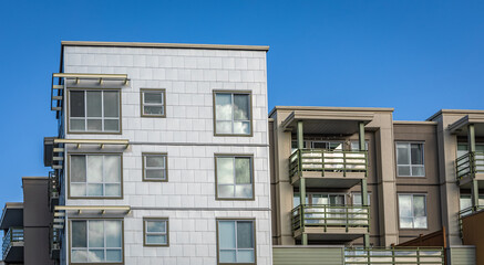 Brand new apartment building on sunny day in BC, Canada. Architectural details of modern apartment building