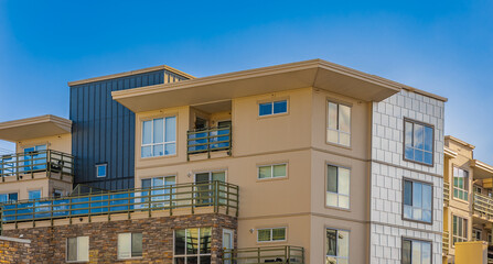 Brand new apartment building on sunny day in BC, Canada. Architectural details of modern apartment building
