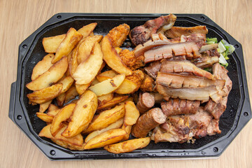 Plate with fried potatoes and smoked meat