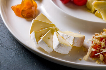 Camembert cut on white plate macro close up