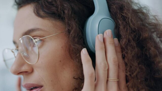 Woman, working and streaming podcast, internet radio or music app at a computer. University student with headphones doing web phd research using technology to listen and study with a focus mindset