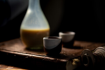 a bottle with caramel liqueur and two shots.