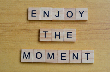 enjoy the moment text on wooden square, inspiration quotes
