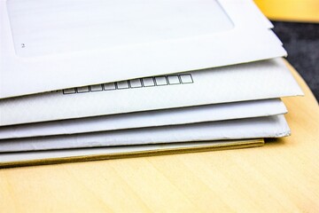 A stack of letters in envelopes. Old paper envelopes with letters.