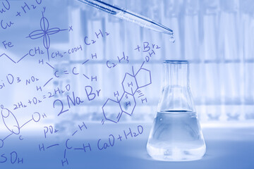 lab flask with dropper drop some blue liquid with blurred background of test tubes in laboratory overlay with chemical molecular