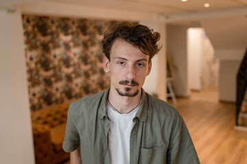 front view portrait of one man modern caucasian male standing indoor