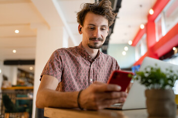One modern caucasian man using mobile phone while stand at cafe