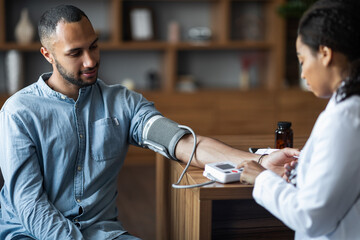 Middle eastern young man having regular checkup at practitioner