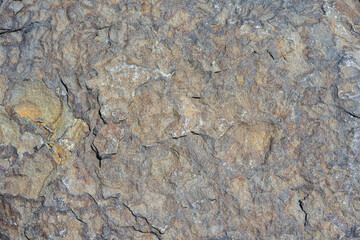 Closeup of multicolor dark rock, patterns and textures in nature as a background
