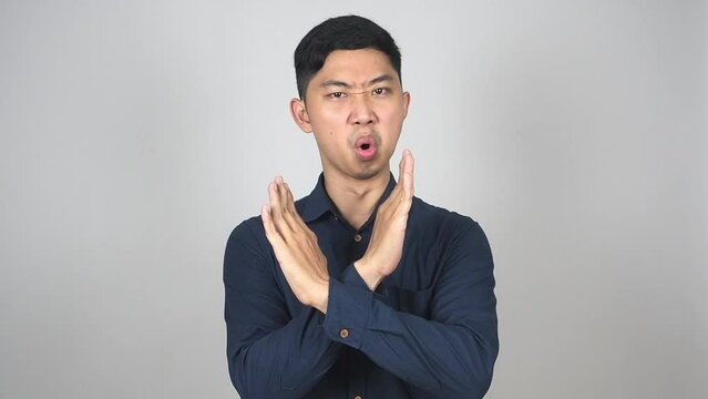 Asian man say no cross arms disagree sign white background