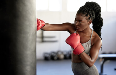 Boxer, workout and training girl with punching bag working on sports fitness, exercise and...