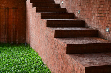 brown brick wall and staircase on green grass