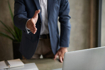 Entrepreneur Outstretching Arm for Handshake