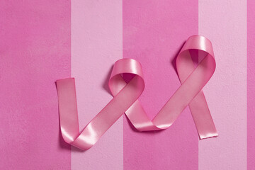 striped background of pink tones with blue and pink ribbons for breast cancer awareness