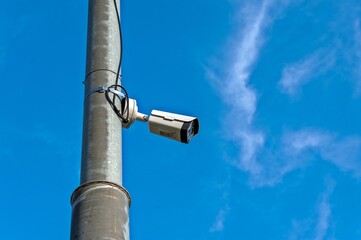 A video camera for surveillance is hanging on a pole