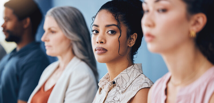 Training, learning and education with a business woman looking serious and sitting in a conference or workshop for coaching. Portrait of a female employee in an audience for a development seminar