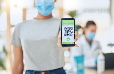 QR code for covid vaccine passport and certificate at covid 19 vaccination center or site for health and safety verification. Hands of young girl with smartphone for approval or confirmation document