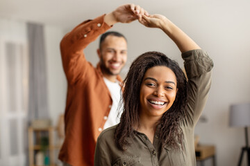 Cheerful African American Couple Dancing Having Fun At Home