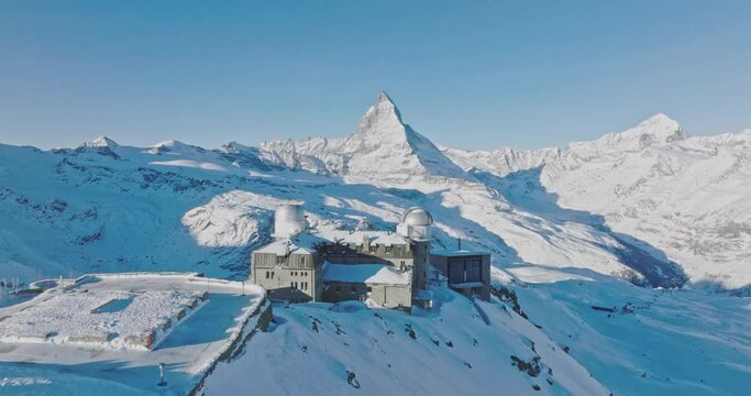 Aerial drone flyover Gornergrat with Matterhorn view during winter in Switzerland. Majestic mountain peaks iconic famous zermatt travel ski resort in the alps. Wonderful inspiring nature landscape.
