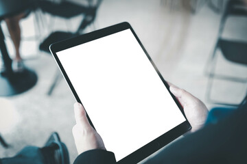 A woman hand showing digital tablet  blank screen on work desk.