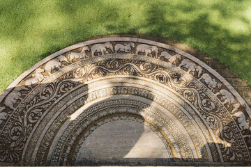 Moonstone also known as Sandakada Pahana, is a unique feature of the architecture of ancient Sri Lanka. It is an elaborately carved semi-circular stone slab, usually placed at the bottom of entrances.