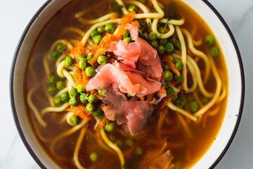 healthy plant-based food, vegan ramen soup with udon noodles peas and pickled ginger