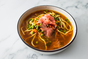healthy plant-based food, vegan ramen soup with udon noodles peas and pickled ginger