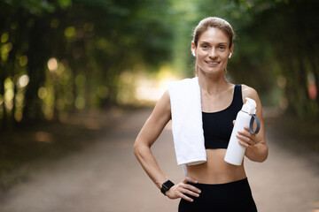 Happy slim lady exercising at public park