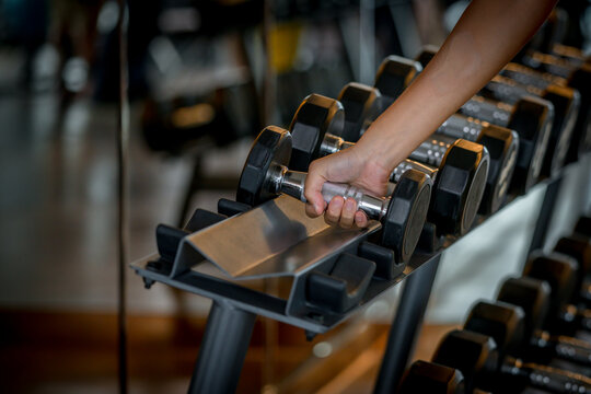 dumbbell equipment at gym  exercise for strong ,make muscle body building and good healthy with black background.