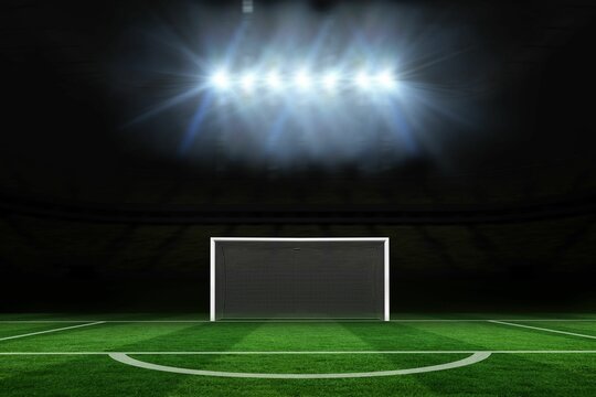 Football pitch under spotlights