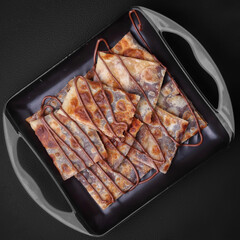 roasted tandoori roti with chocolate arrange in a dish dark background studio photography
