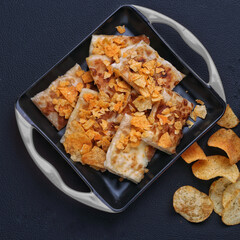 roasted tandoori roti with snacks arrange in a dish dark background studio photography
