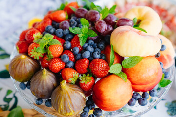 assorted fruits and berries on a plate. delicious and healthy vegetarian dessert