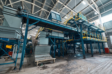 Fototapeta na wymiar Large production line with conveyors carrying trash at plant