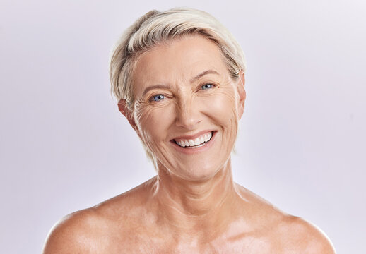 Beauty and skincare of a senior woman with smooth skin and healthy teeth against a pink background. Portrait of a happy mature, elderly or old female smiling due to cosmetic wellness