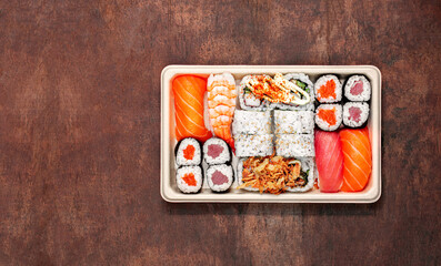Sushi box on a wooden background. Japan restaurant menu. Sushi  Top view. Copyspace