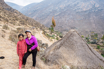 older Caucasian woman, hiking in the mountains with her Latina granddaughter.