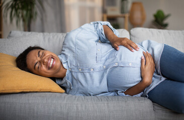 Pregnant African American Female Having Painful Contractions Spasm At Home