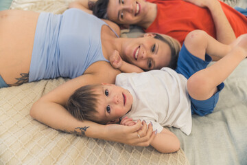 Healthy family relationships. Caucasian heterosexual married couple lying on the bed with their...