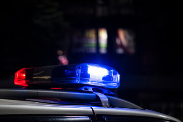 Obraz premium Emergency light of police patrolling car on street in night