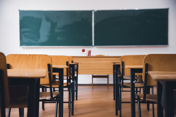 Elementary classroom, no kid or teacher, with chairs and tables. Education concept.
