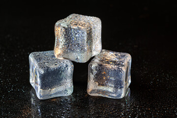 ice cubes on black table background.