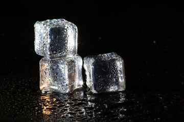 ice cubes on black table background.