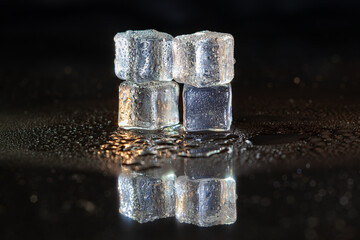 ice cubes on black table background.