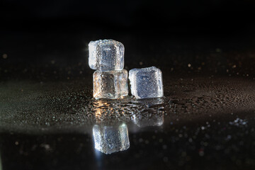 ice cubes on black table background.