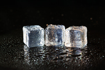 ice cubes on black table background.
